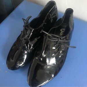 Jeffrey Campbell shiny black leather lace-up flats.